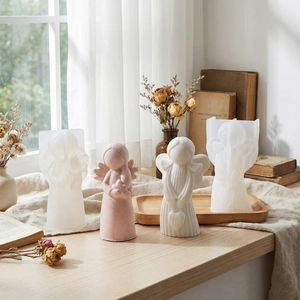 DIY silicone molds and finished angel-shaped candles with detailed wings for home decor