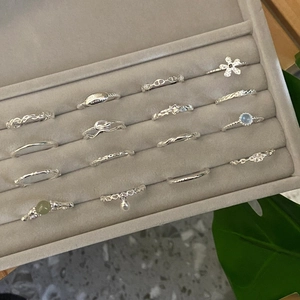 Stackable 925 sterling silver rings set with pearls and blue stones in a velvet box