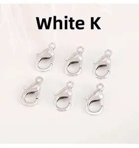 Close-up of six silver lobster clasps for DIY jewelry making on a white background