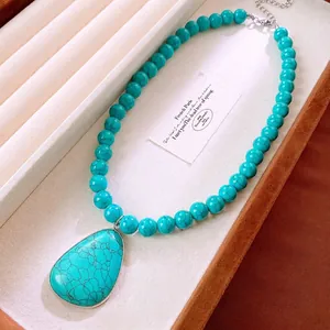 Vintage beaded turquoise drop pendant necklace with a natural teardrop stone and silver clasp