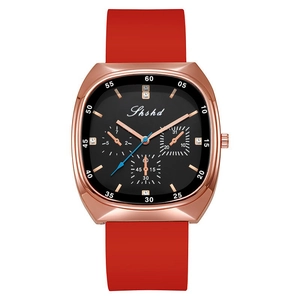 Detailed macro view of rose gold watch case with crystal markers and red silicone strap