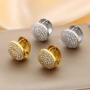 Macro shot of 18K gold and silver hoop earrings with micro-paved sparkling zircon stones