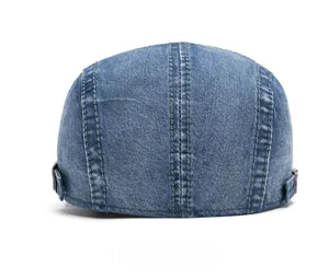 Rear view of washed blue denim beret cap featuring adjustable metal side buckles