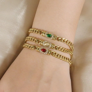Golden Cuban link bracelet featuring colorful cat eye stones and sparkling crystal accents