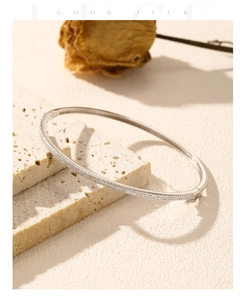 Macro shot of silver S925 sterling silver bangle with pavé-set sparkling cubic zirconia
