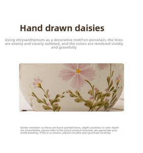 Detail of hand-painted daisy pattern on cream ceramic teacup with delicate floral texture