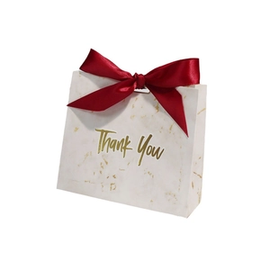 Elegant white marble gift bag with Thank You gold foil print and red ribbon bow