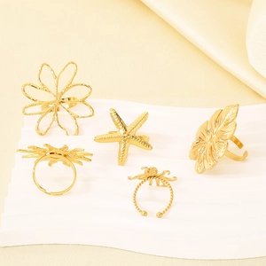 Golden stainless steel ring set featuring cutout flowers starfish and tropical leaves
