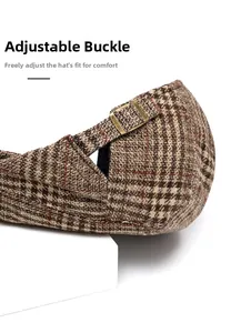 Detail of adjustable metal buckle on brown plaid beret hat for size adjustment
