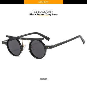 Side view of retro round frame punk sunglasses in black with grey lenses and metal rivets
