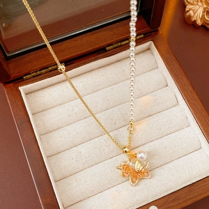 Detail of necklace with gold unicorn pendant and mixed metal and pearl chain
