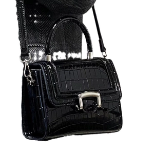 Elegant black crocodile pattern handbag with silver arched hardware on a white background