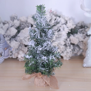 Mini artificial snowy Christmas tree with pine needles and burlap base desktop ornament