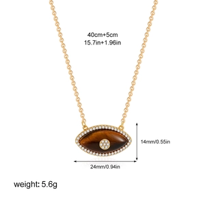 Detailed view of the Evil Eye pendant with Tiger Eye stone and zircon on a gold-plated chain