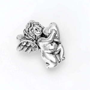 Detailed view of vintage silver angel brooch with intricate wing texture and relief