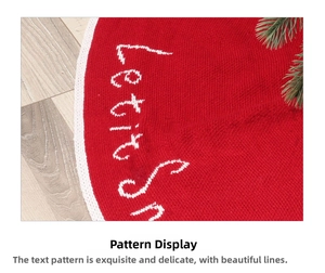 Macro shot of red knit Christmas tree skirt with white Let it Snow embroidery detail