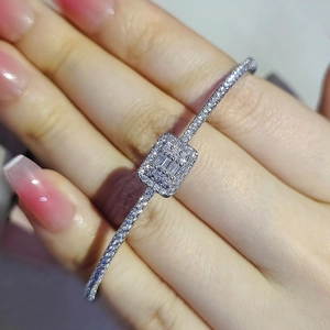Elegant silver rectangle bangle with micro-paved zircons worn on a female wrist