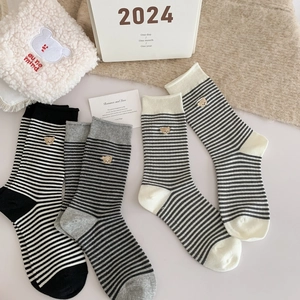 Striped cotton crew socks with bear embroidery in various classic colors on a soft surface