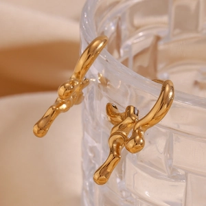 Macro shot of 18K gold plated stainless steel earrings with irregular liquid metal texture