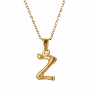 Close-up of gold stainless steel bamboo textured necklace featuring a letter Z pendant