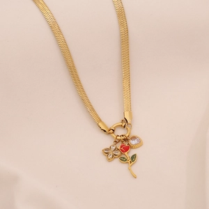 Detail of gold snake chain necklace with enamel red rose and heart zircon pendants