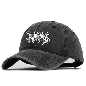 Close-up of the washed black cotton fabric and white gothic embroidery on baseball cap