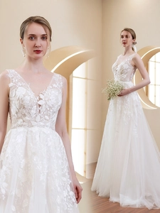 Close-up of elegant V-neck lace bodice and intricate embroidery on a bridal wedding gown