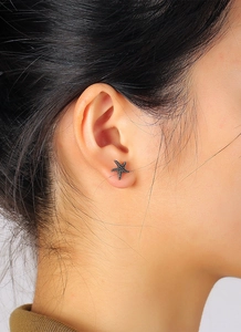 Close-up of a model wearing the antique silver starfish stud earring with ocean motifs
