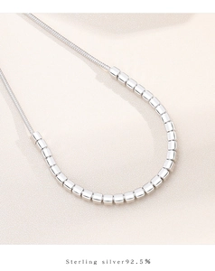 Macro detail of S925 sterling silver snake chain with polished cubic silver beads