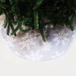 Detailed view of white faux fur Christmas tree skirt with plush snowflake patterns