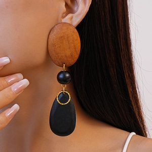 Vintage geometric wooden bead drop earrings featuring black resin charms and gold rings