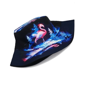 Detailed close-up of flamingo and pine forest print on black bucket hat with stitched brim