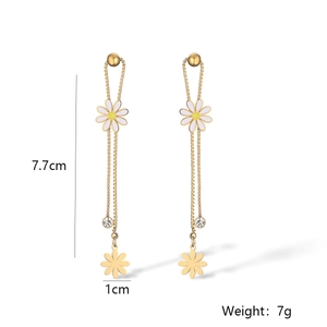 Detailed view of 18K gold plated long tassel earrings with white daisies and clear zircon