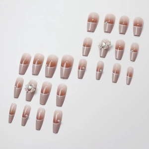 Baroque French press-on nails with 3D bows, pearls, and nude gradient coffin style