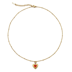 Detail of gold titanium steel necklace featuring a red enamel heart pendant and beaded chain