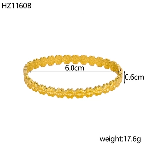 Detailed view of 18K gold plated wide cuff bangle with floral pattern and dimensions