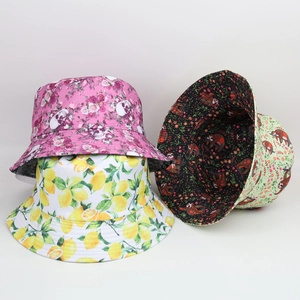 Detail showing various reversible bucket hats with rose skull, lemon, and floral patterns