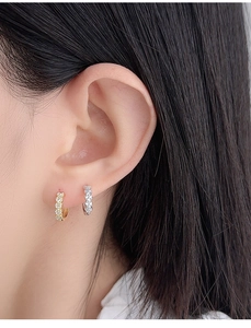 Detailed view of S925 sterling silver hoop earrings with zircon on a female model