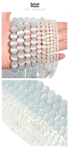 Macro detail of multi-size light blue and white cat's eye beads for DIY jewelry making