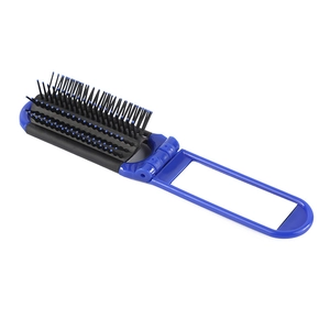 Detail view of foldable blue massage hairbrush with black bristles and round tips