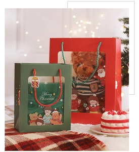 Close-up of Christmas gift bags with transparent windows and braided handles