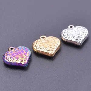 Macro shot of colorful, gold, and silver heart pendants for DIY jewelry making