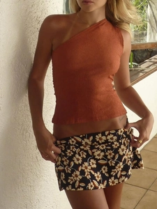 Floral high waist mini skirt paired with a rust red textured one shoulder top