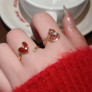 Detail of 18k gold plated heart open rings with red enamel, pearls and zircon accents