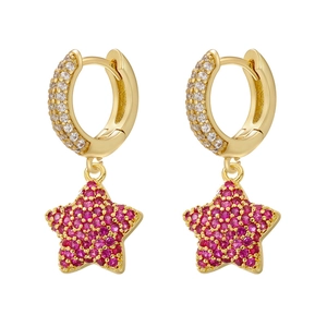 Detailed close-up of gold star earrings featuring micro-pave ruby colored gemstones