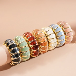 Detail of colorful acrylic resin marble bangles with elegant gold alloy frames