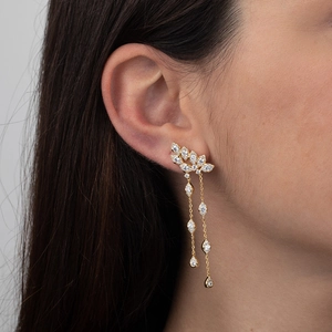 Elegant gold tassel earrings with clear zircon stones on a model to show stylish fit