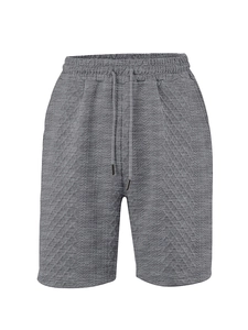 Detailed view of grey knitted shorts featuring textured patterns and adjustable drawstring waist
