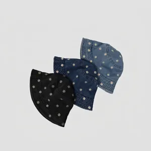 Three colors of denim bucket hats with daisy embroidery in black, dark and light blue