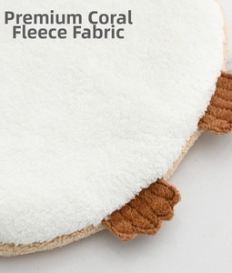 Close-up of premium coral fleece fabric texture showing soft fibers and brown trim